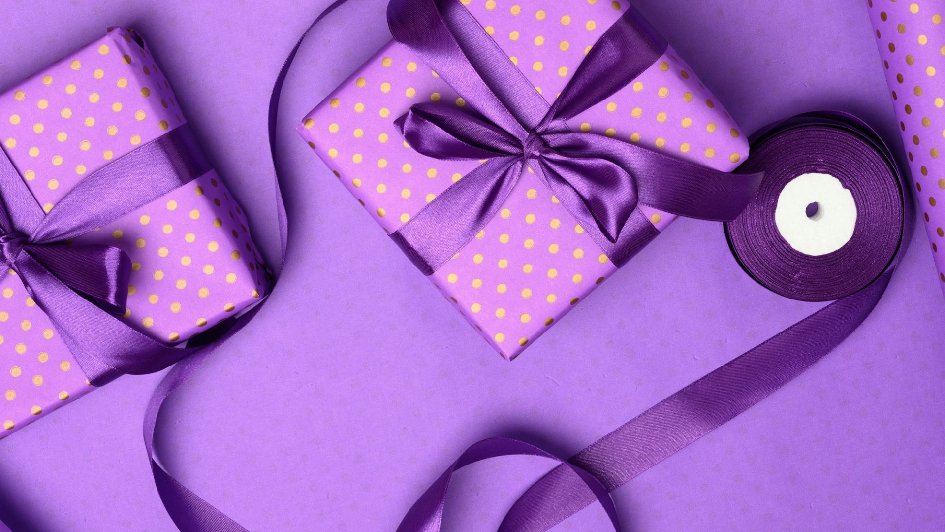 purple-gift-box-wrapped-in-silk-ribbon-on-a-purple-background.jpg